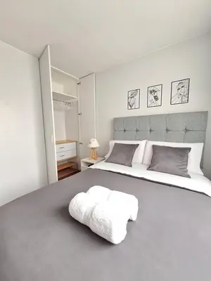 a bedroom with a large bed with two towels on it at Miraflores - Dormitorio en Departamento compartido Baño Exclusivo Externo in Lima