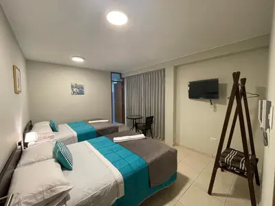 a hotel room with two beds and a television at Vianca Hotel in Machu Picchu
