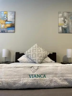 a bed in a room with two pillows on it at Vianca Hotel in Machu Picchu