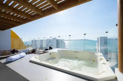 a bath tub in a room with a view of the ocean at Sotavento Oceanfront Condos by Vibrant in Paracas