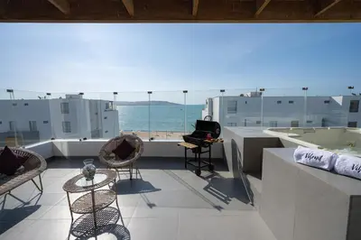 a balcony with chairs and a view of the ocean at Sotavento Oceanfront Condos by Vibrant in Paracas