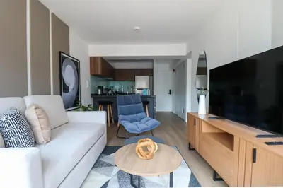 a living room with a white couch and a table at Gray by Wynwood House in Lima