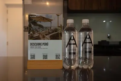 three empty plastic bottles sitting on top of a table at Gray by Wynwood House in Lima
