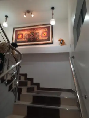a stairway with a painting and a picture on the wall at BRISAS DE LA BAHIA HOTEL in Paracas