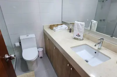 a bathroom with a sink and a toilet and a mirror at Amazing 3BR in Miraflores in Lima