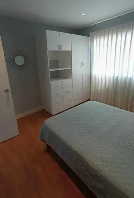 a bedroom with a bed and white cabinets and a window at Live, Work & Comfort San Isidro in Lima