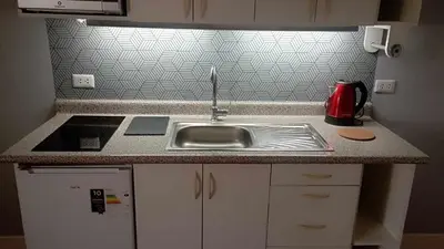 a kitchen with a sink and a counter top at Live, Work & Comfort San Isidro in Lima