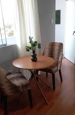 a table and two chairs with a plant on top of it at Live, Work & Comfort San Isidro in Lima