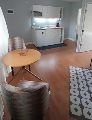 a kitchen with a table and chairs in a room at Live, Work & Comfort San Isidro in Lima