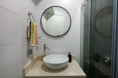a bathroom with a white sink and a mirror at Apartamento con increíble vista al mar in Lima