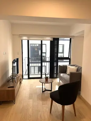 a living room with a couch and a table at Departamento de Estreno en Miraflores in Lima
