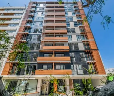 a tall building with balconies on the side of it at Departamento de Estreno en Miraflores in Lima