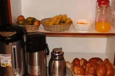 a kitchen counter with baskets of fruit on a shelf at MACHUPICCHUROYAL B y B in Machu Picchu