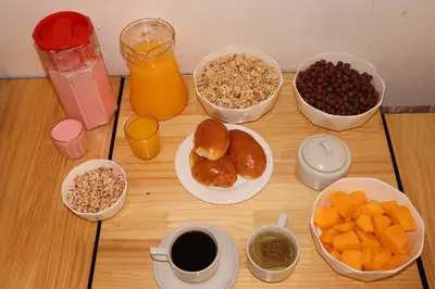 a table topped with bowls of breakfast foods and drinks at MACHUPICCHUROYAL B y B in Machu Picchu