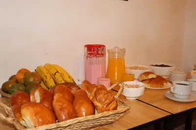 a table topped with a basket of bread and fruit at MACHUPICCHUROYAL B y B in Machu Picchu