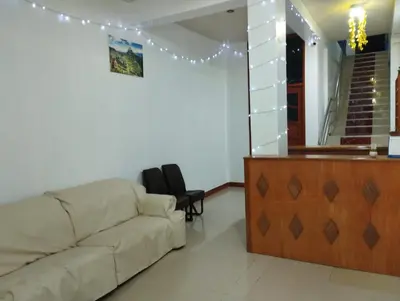 a living room with a couch and a counter at hotel plaza chinchero in Cusco