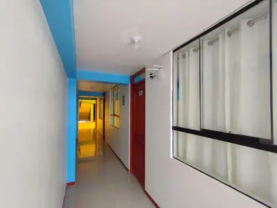 a hallway with blue and red doors in a building at hotel plaza chinchero in Cusco