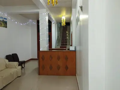 a living room with a couch and a mirror at hotel plaza chinchero in Cusco