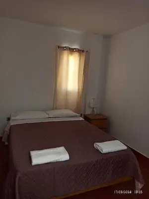 a bedroom with a bed with two towels on it at El Capricho II Paracas in Paracas