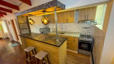 a kitchen with a counter and a stove top oven at Apart Hotel de Alegria in Cusco