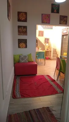 a living room with a red couch on the floor at Colores Hospedaje Miraflores in Lima