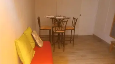 a living room with a couch and a table with chairs at Colores Hospedaje Miraflores in Lima