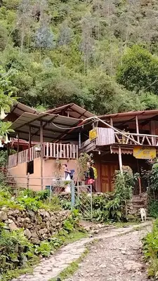 a house on the side of a mountain at HOSTEL SAMANA WASI CHAULLAY in Cusco