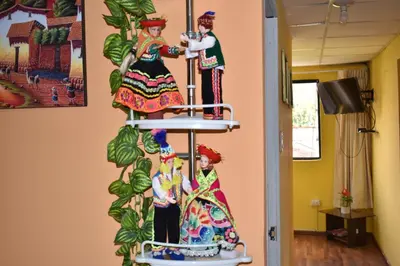 a colorful display of dolls in a room at Saga Andina II in Cusco