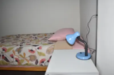a desk with a lamp on top of a bed at Saga Andina II in Cusco