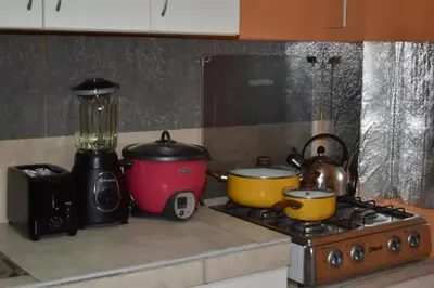 a stove top with two pots and pans on it at Saga Andina II in Cusco