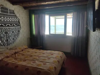 a bedroom with a bed and a window at Beach House SantaElena in Pisco