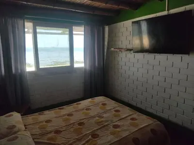 a bedroom with a bed with a view of the ocean at Beach House SantaElena in Pisco