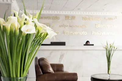 a chair and a vase of flowers in a lobby at Luxury Inkari Hotel in Lima