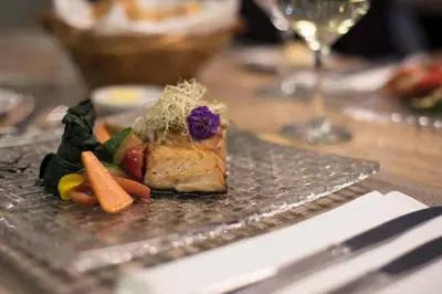 a plate of food with vegetables on a table at Luxury Inkari Hotel in Lima