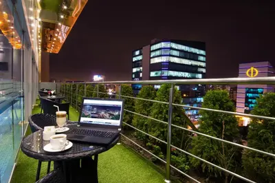 a laptop computer sitting on a table on a balcony at Luxury Inkari Hotel in Lima