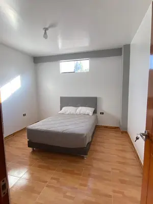a bedroom with a bed in the middle of it at Casa Hospedaje El Trebol in Oxapampa