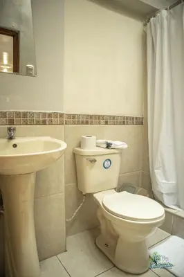 a bathroom with a toilet and a sink at BEAUTIFUL, SPACIOUS & COZY HOUSE LOCATED IN THE HEART OF CUSCO in Cusco