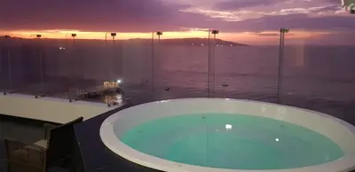 a large bath tub with a view of the ocean at Nuevo Paracas Apartment in Paracas