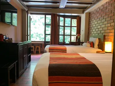 a hotel room with two beds and a window at Panorama B&B in Machu Picchu
