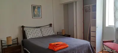a bedroom with a bed with an orange towel on it at Bonito Apartamento en Miraflores in Lima