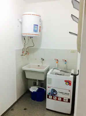 a small bathroom with a sink and a washing machine at Bonito Apartamento en Miraflores in Lima