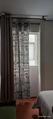 a bedroom with a curtain and a window at Bonito Apartamento en Miraflores in Lima