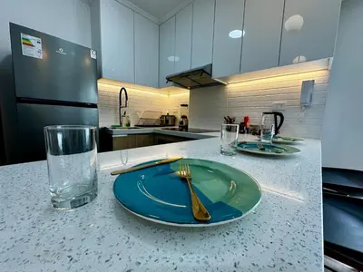 a green plate with a fork on a counter in a kitchen at Cozy Apartment in Barranco! in Lima