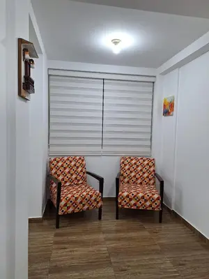two chairs sitting in a room with a window at Dormitorio matrimonial 02 in Lima