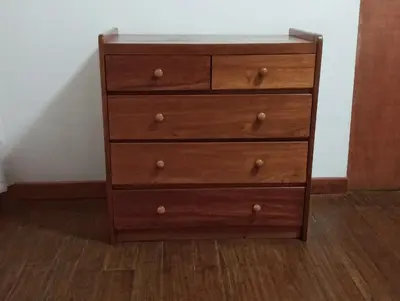 a wooden dresser with four drawers in a room at Casa Verde in Quillabamba