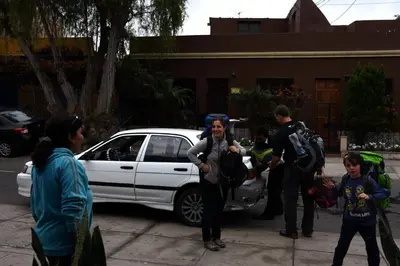 a group of people standing around a white car at Casita Libertad Barranco in Lima