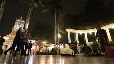 a group of people standing in front of a building at night at Casita Libertad Barranco in Lima