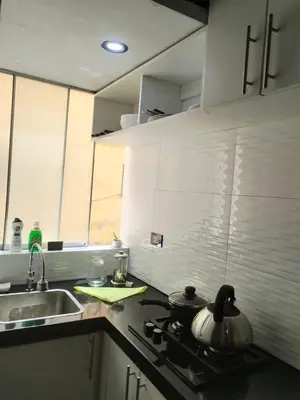 a kitchen with a sink and a stove top oven at Apartamento estándar en Lima Centro in Lima