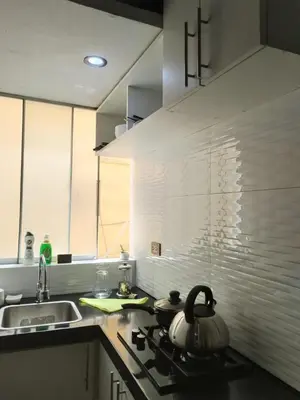 a kitchen with a stove with a tea kettle on it at Apartamento estándar en Lima Centro in Lima