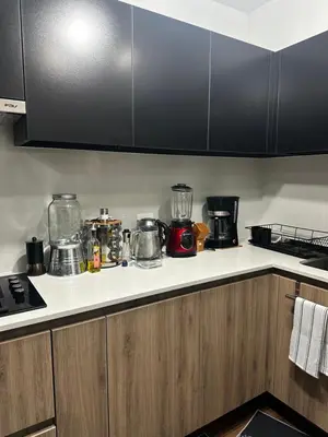 a kitchen with a counter top with many appliances at Departamento Calido y familiar in Lima
